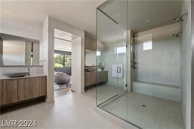 bathroom with tile patterned flooring, an enclosed shower, and vanity