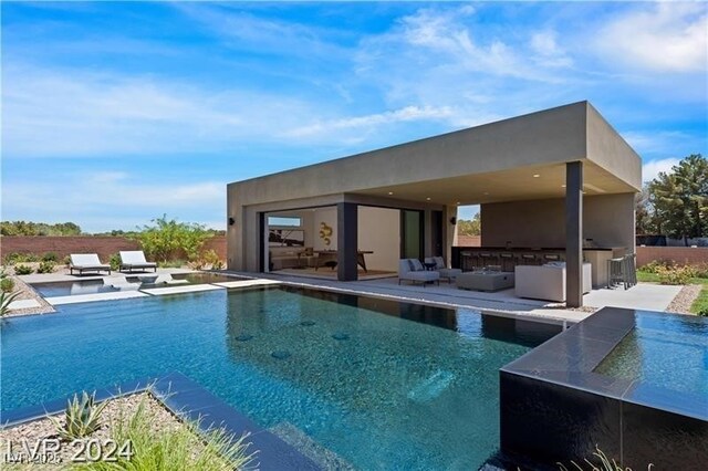 view of swimming pool featuring a patio area and a bar