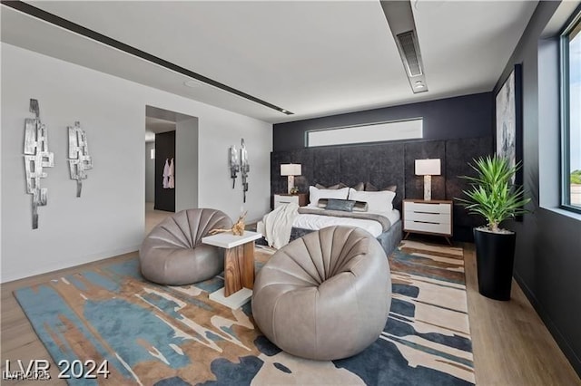 bedroom featuring light hardwood / wood-style flooring and multiple windows