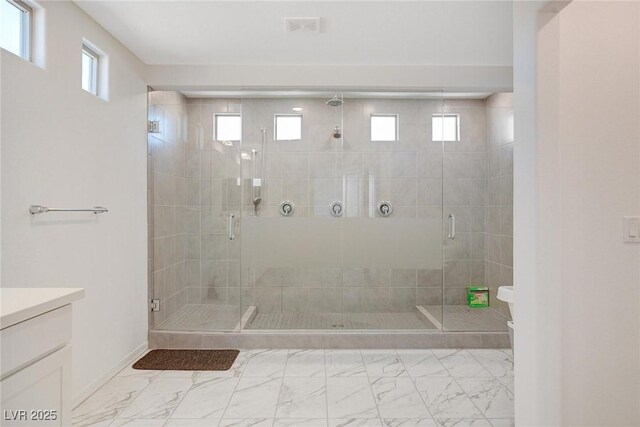 bathroom featuring vanity and a shower with shower door