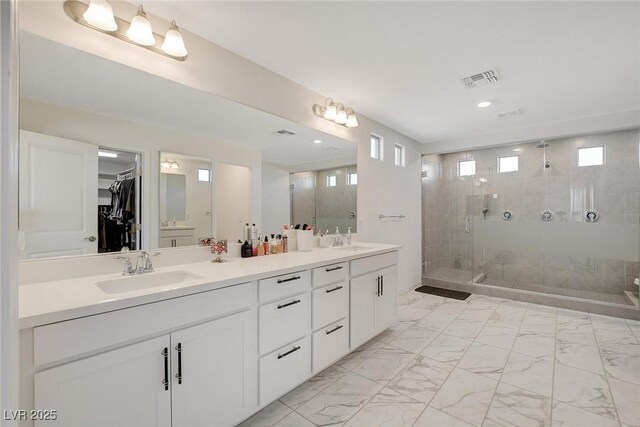 bathroom featuring walk in shower and vanity