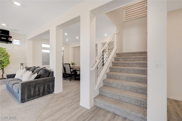 stairway with hardwood / wood-style floors