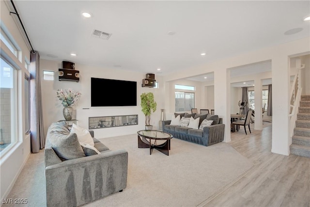 living area with visible vents, wood finished floors, stairway, and recessed lighting