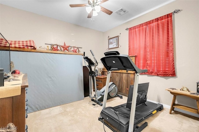 workout area with ceiling fan and carpet