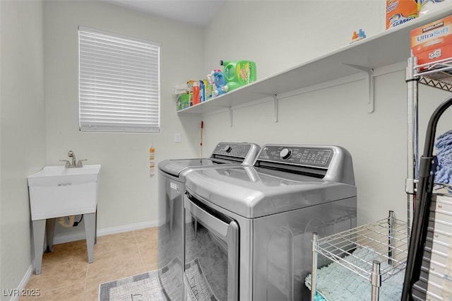 laundry room with separate washer and dryer and light tile patterned floors