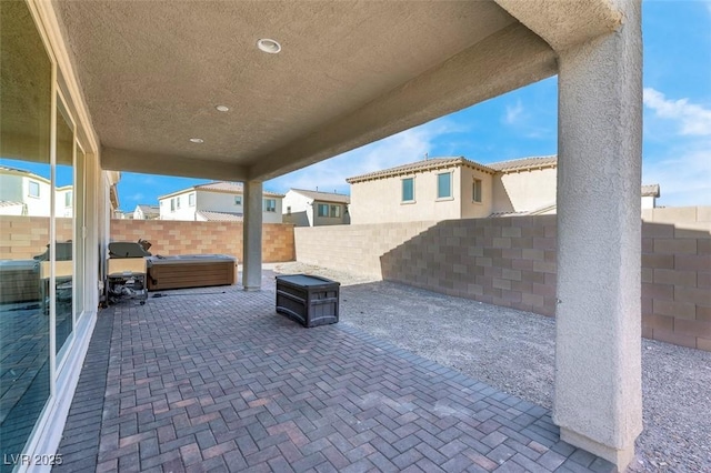 view of patio / terrace featuring grilling area and a hot tub