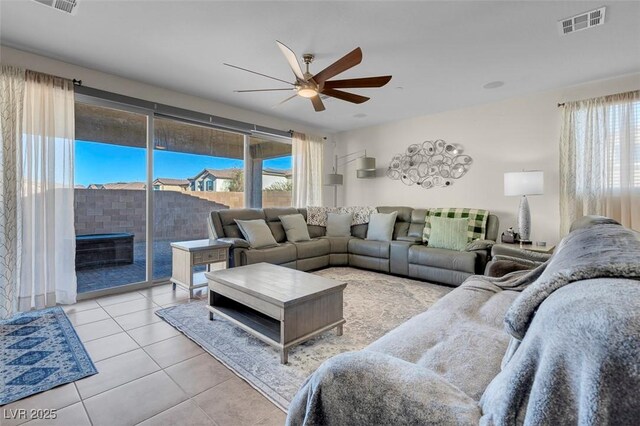 living room with ceiling fan and light tile patterned floors