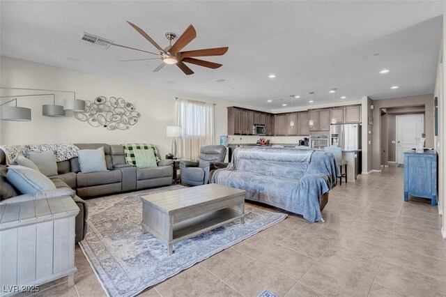 living room with ceiling fan and light tile patterned floors