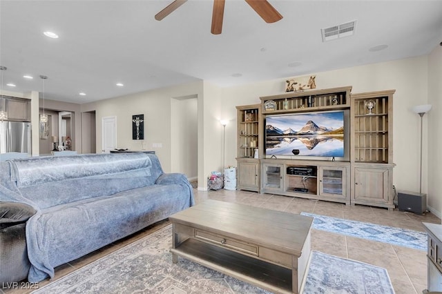 tiled living room with ceiling fan