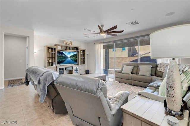 living room with ceiling fan and light tile patterned floors