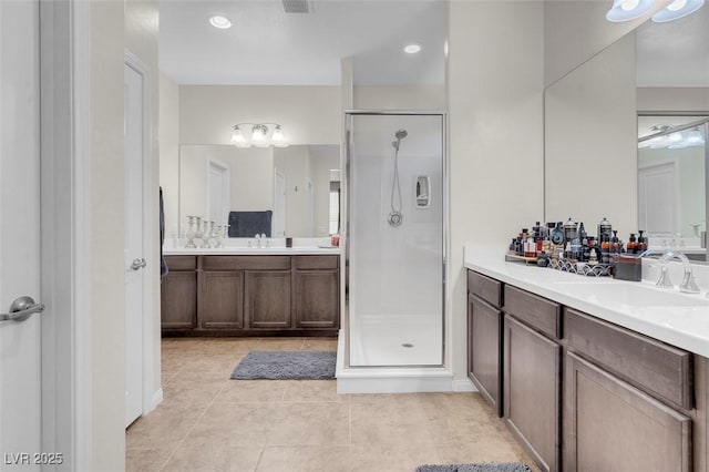 bathroom featuring walk in shower, tile patterned floors, and vanity