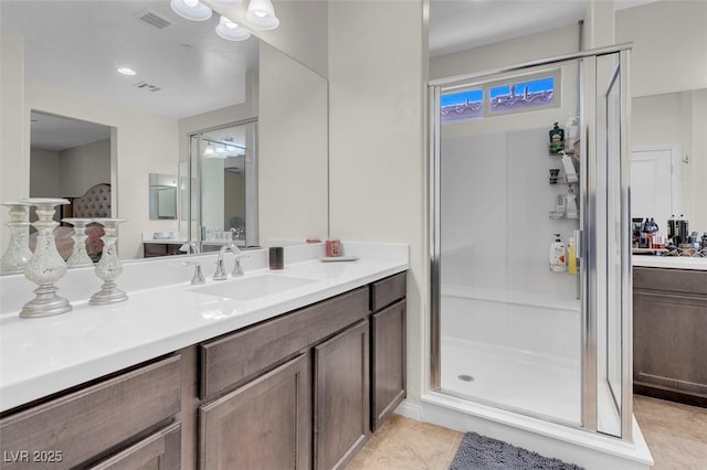 bathroom with tile patterned floors, vanity, and walk in shower