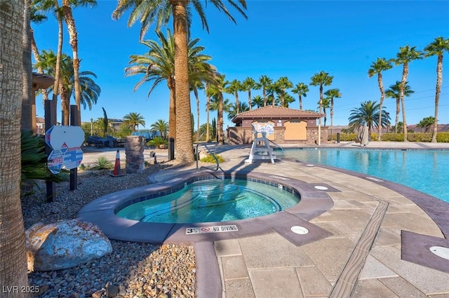 view of swimming pool featuring a patio and a community hot tub