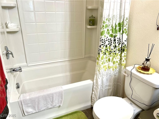 bathroom featuring shower / bath combo with shower curtain and toilet