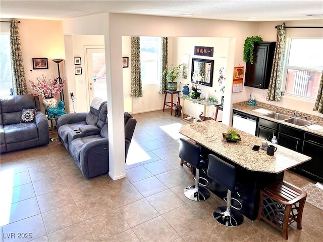 living room with sink and light tile patterned flooring