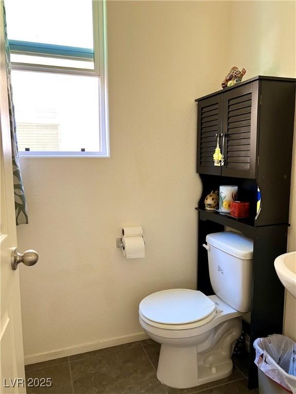 bathroom featuring toilet and tile patterned floors