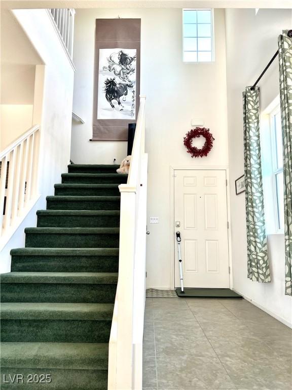 tiled entrance foyer with a high ceiling