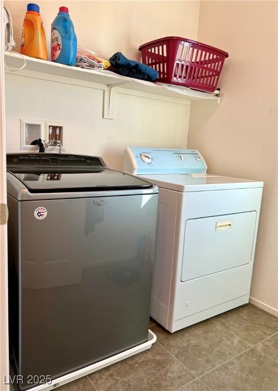 washroom featuring tile patterned flooring and washer and clothes dryer