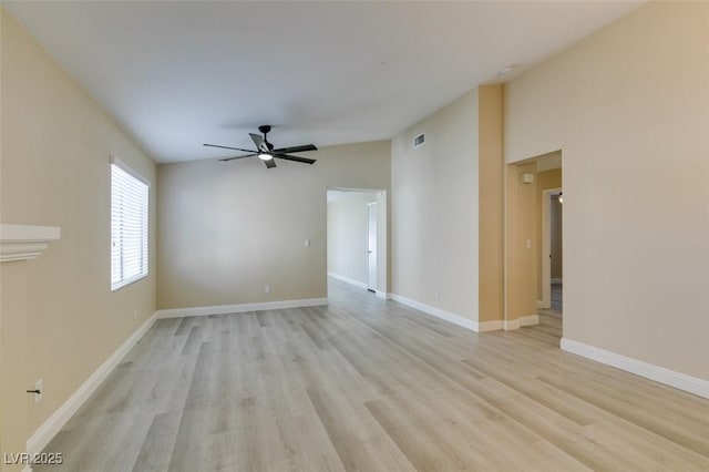 empty room featuring ceiling fan, light hardwood / wood-style floors, and lofted ceiling