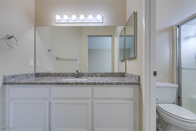 bathroom with vanity, toilet, and an enclosed shower