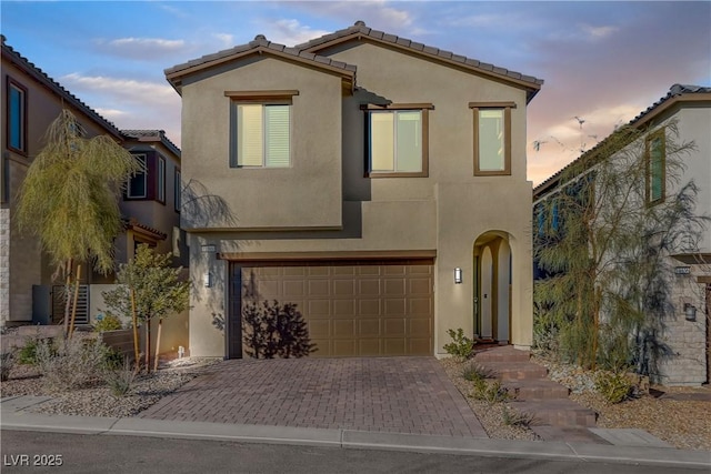 mediterranean / spanish-style house with a garage