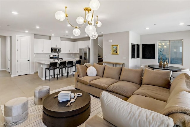 living area featuring recessed lighting, a notable chandelier, baseboards, and stairs