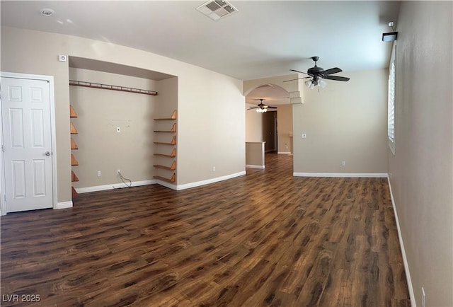 unfurnished living room with ceiling fan and dark wood-type flooring