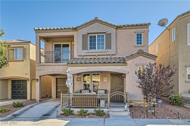 mediterranean / spanish-style house with a porch, a garage, and a balcony