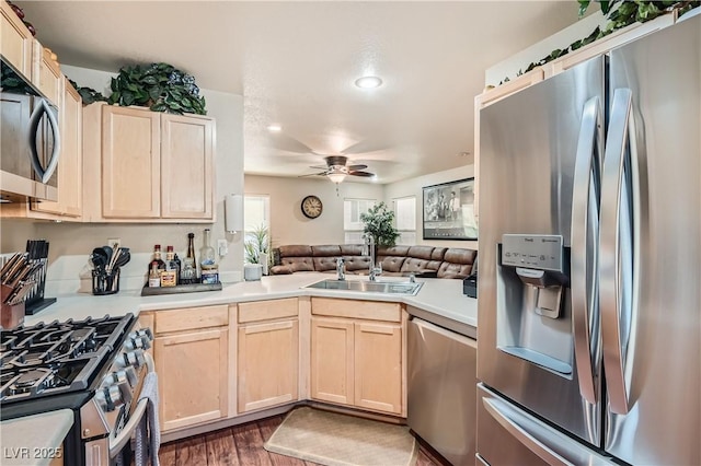 kitchen featuring ceiling fan, sink, dark hardwood / wood-style flooring, stainless steel appliances, and light brown cabinets