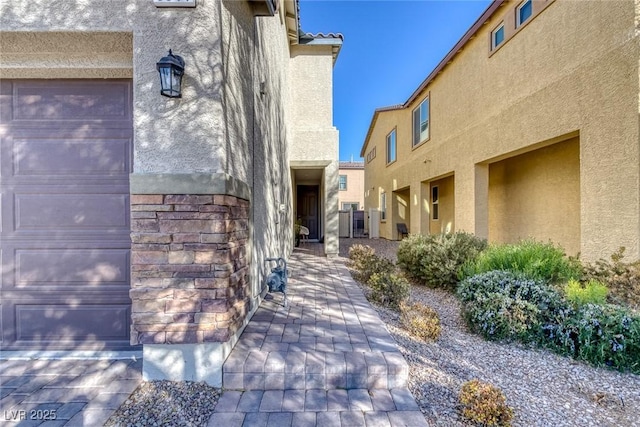 doorway to property with a garage