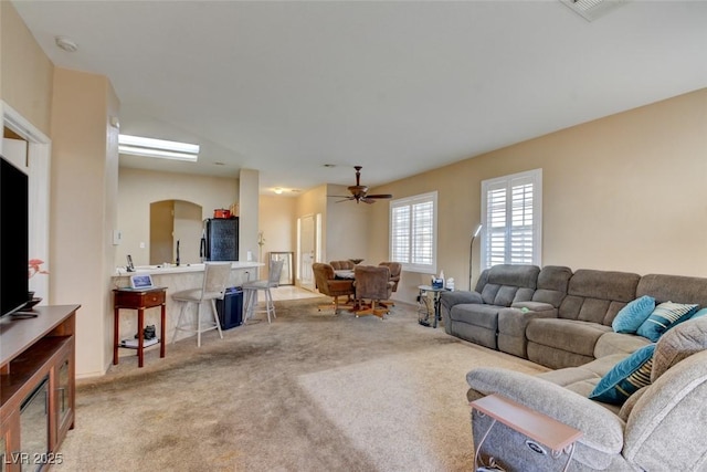 living room with light carpet and ceiling fan