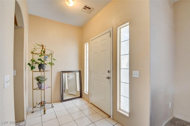 tiled entryway featuring a healthy amount of sunlight