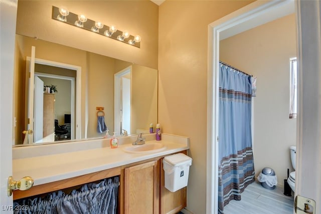 bathroom with vanity, toilet, walk in shower, and wood-type flooring