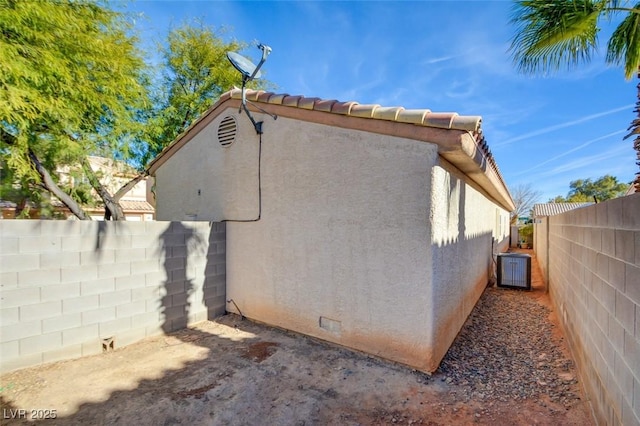 view of property exterior with central AC