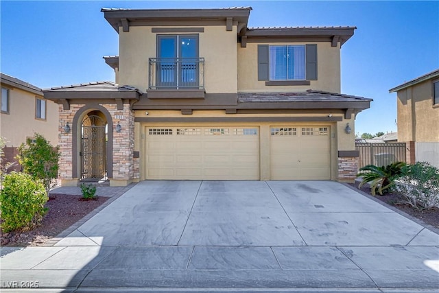 view of front of home featuring a garage, stone siding, concrete driveway, and stucco siding