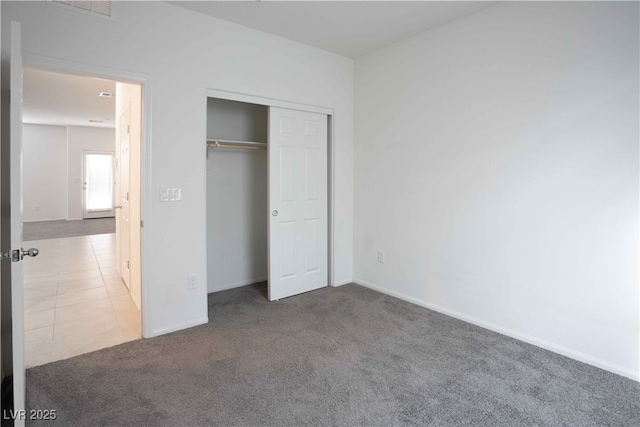 unfurnished bedroom with carpet flooring and a closet