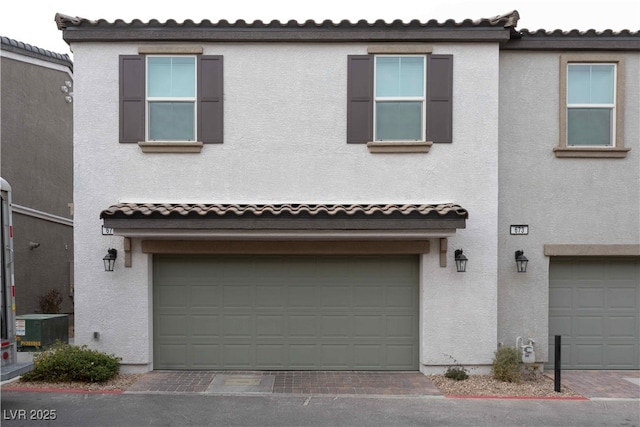 mediterranean / spanish home with central AC and a garage