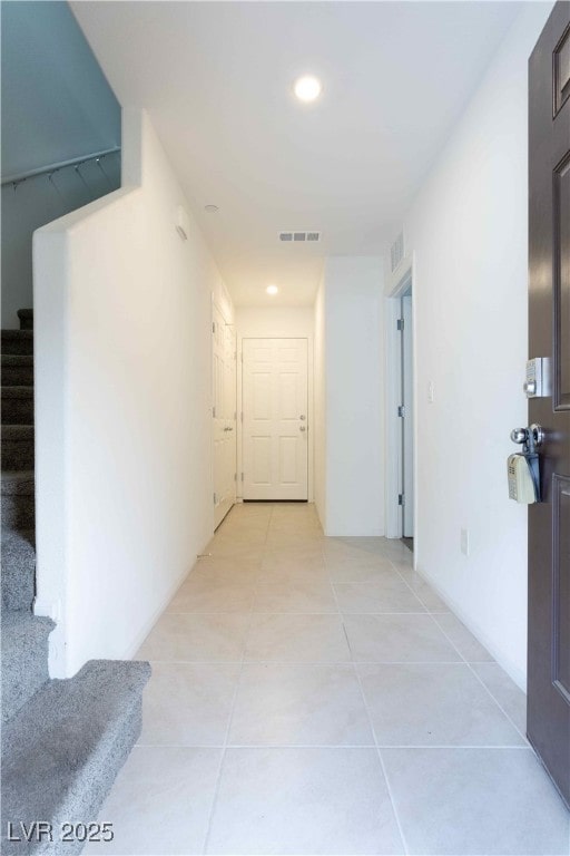 corridor with light tile patterned floors