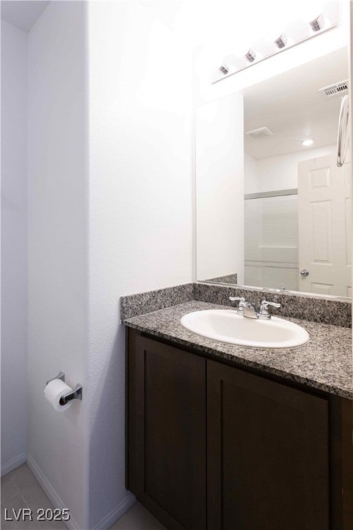 bathroom featuring a shower, vanity, and tile patterned floors