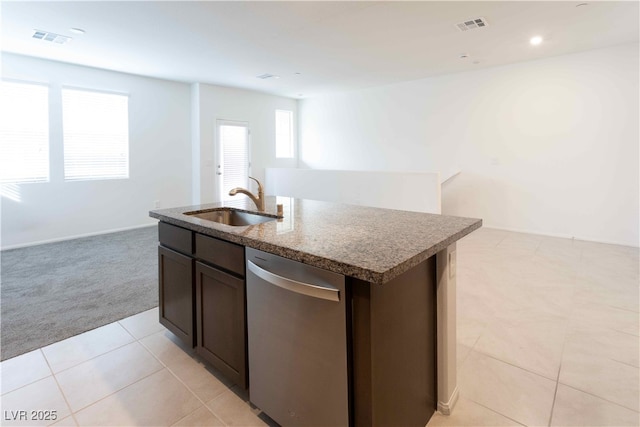 kitchen with dark brown cabinetry, sink, light carpet, dishwasher, and an island with sink