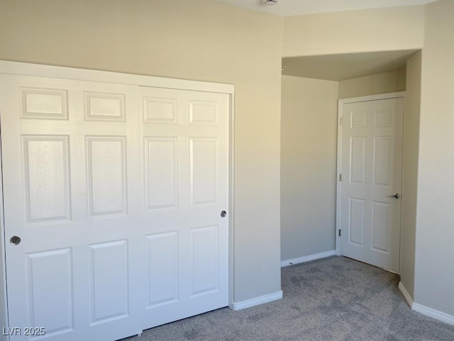 unfurnished bedroom with light carpet and a closet