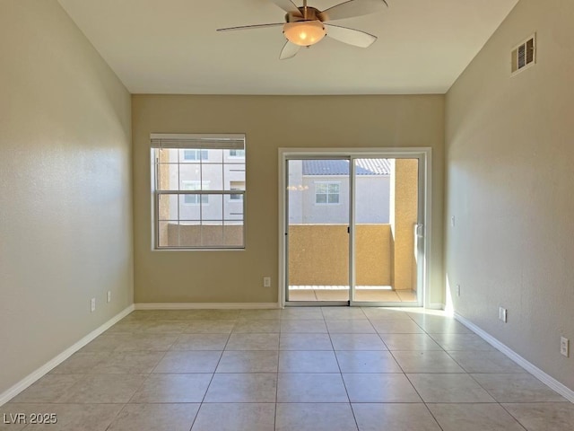 tiled empty room featuring ceiling fan