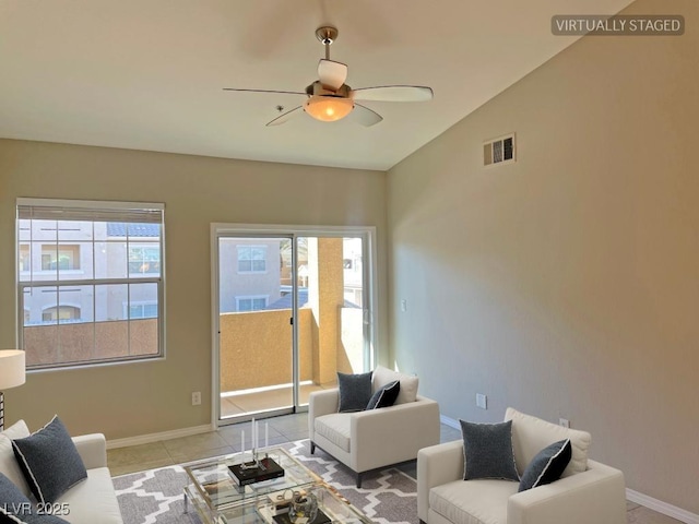 tiled living room featuring plenty of natural light, vaulted ceiling, and ceiling fan