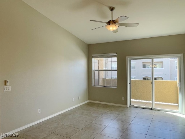 spare room featuring ceiling fan, light tile patterned floors, and vaulted ceiling