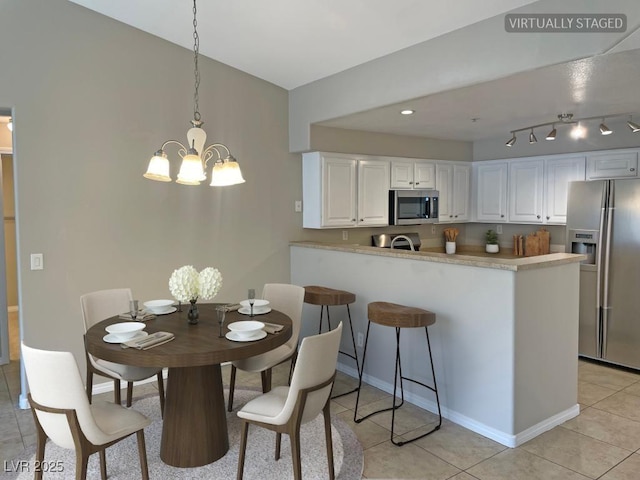 tiled dining area featuring a chandelier