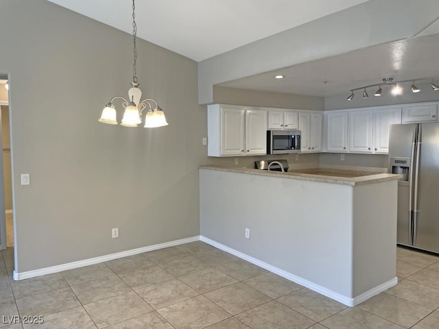 kitchen with kitchen peninsula, hanging light fixtures, white cabinets, and stainless steel appliances