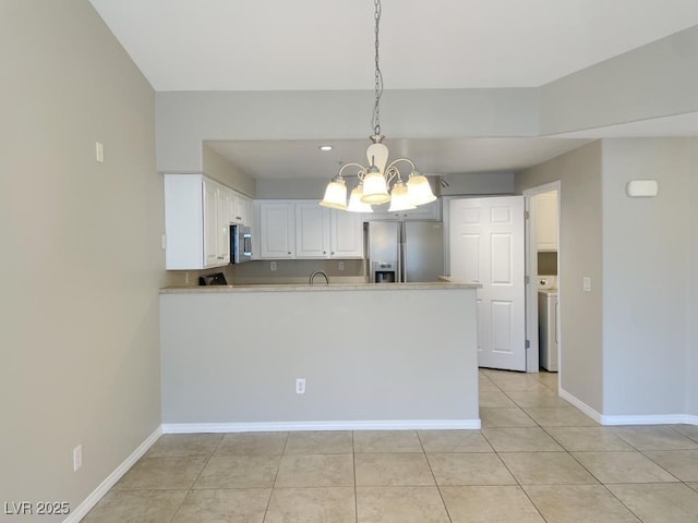 kitchen featuring kitchen peninsula, pendant lighting, appliances with stainless steel finishes, white cabinets, and light tile patterned flooring