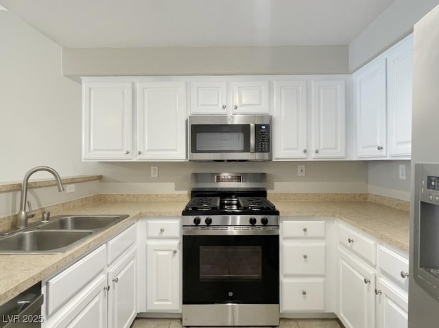 kitchen with sink, white cabinetry, and appliances with stainless steel finishes