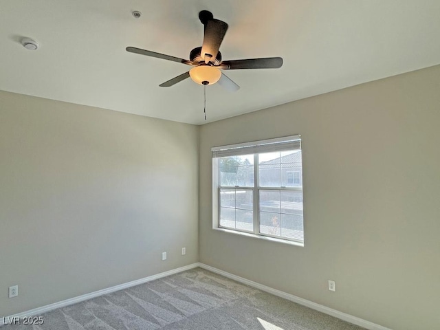 spare room featuring ceiling fan and light colored carpet