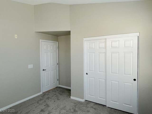 unfurnished bedroom with light colored carpet and a closet